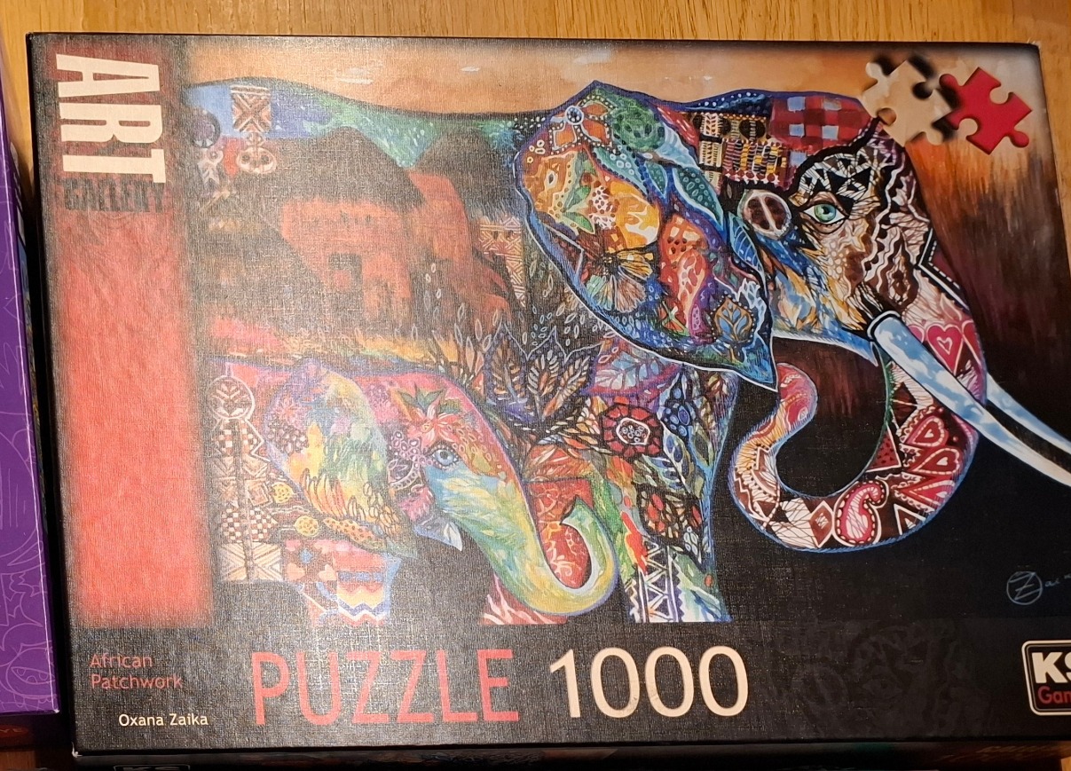 A stylized illustration of a large elephant with a smaller calf, both decorated in vibrant, patchwork-style patterns.