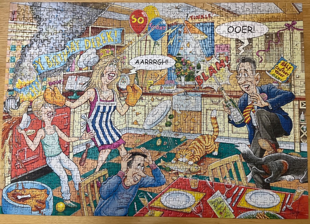 Cartoon of a chaotic birthday party in a kitchen with people, a cat, and a dog.