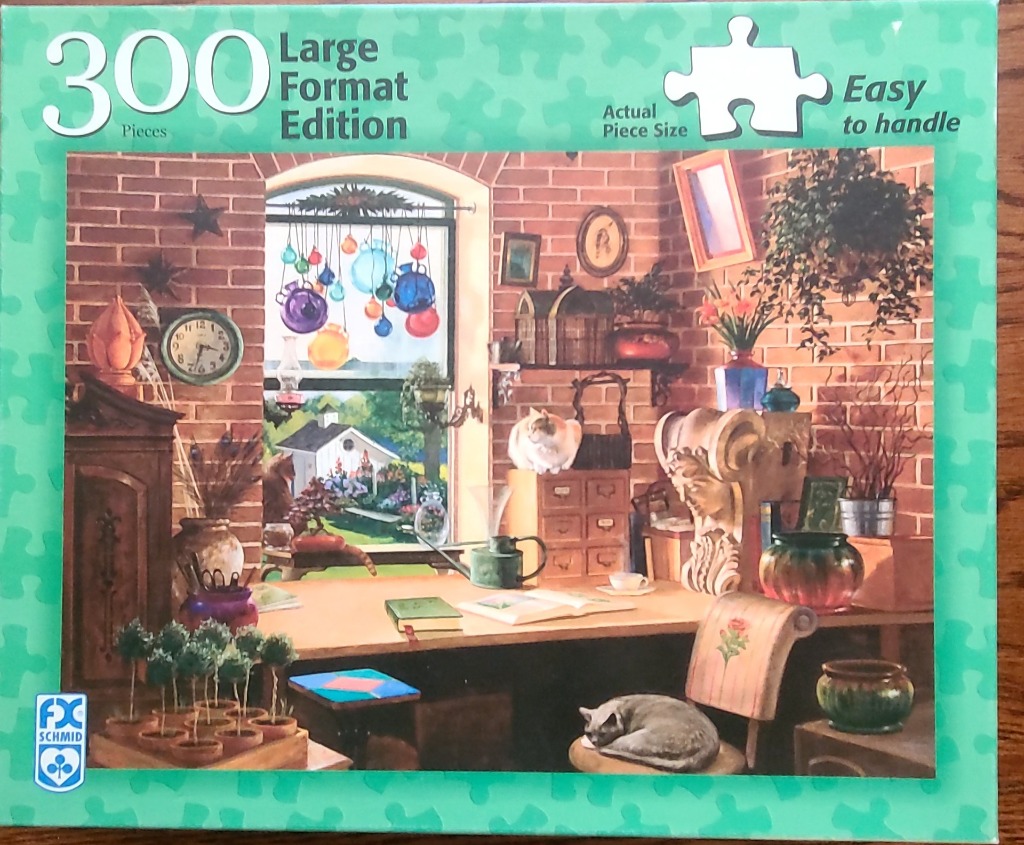 Cozy sunlit room filled with plants, cats, and various art objects by a window overlooking a garden.