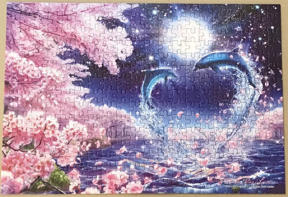 Two dolphins leaping from a moonlit ocean next to blooming pink cherry blossom trees.