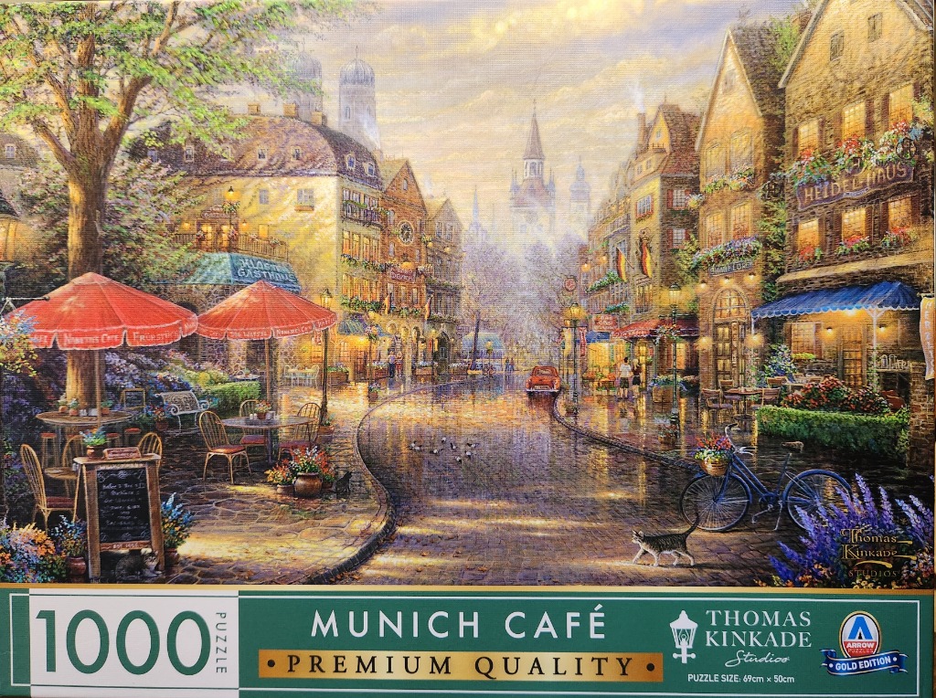 An impressionist painting of a Munich street scene with cafes, cobblestone streets, and a bicycle.