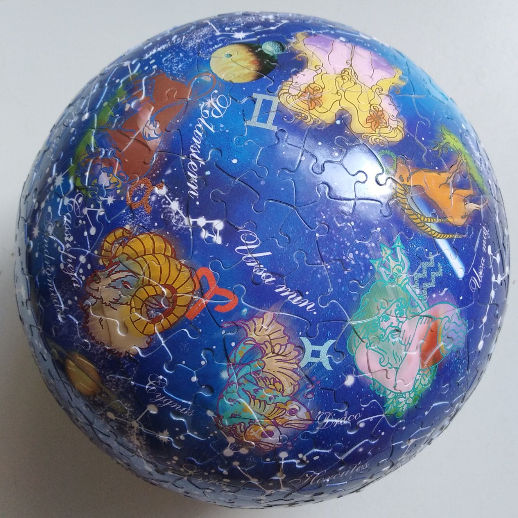 A spherical representation of the night sky featuring various zodiac signs and constellations in a stylized illustration.