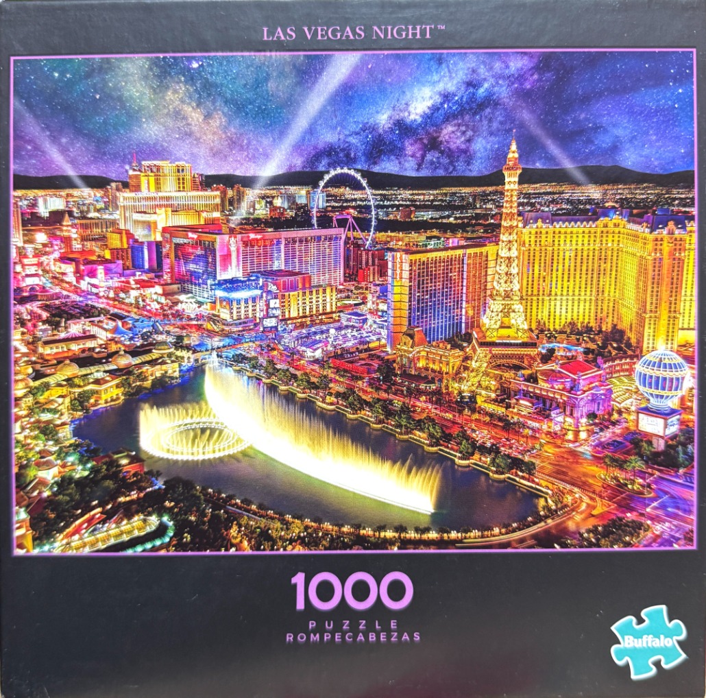 Nighttime aerial view of the Las Vegas Strip featuring the Bellagio fountains under a brilliant starry sky.