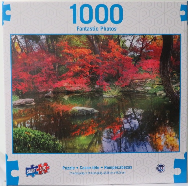 A serene photograph of a Japanese garden in autumn with vibrant red maple trees reflected in a dark, still pond.