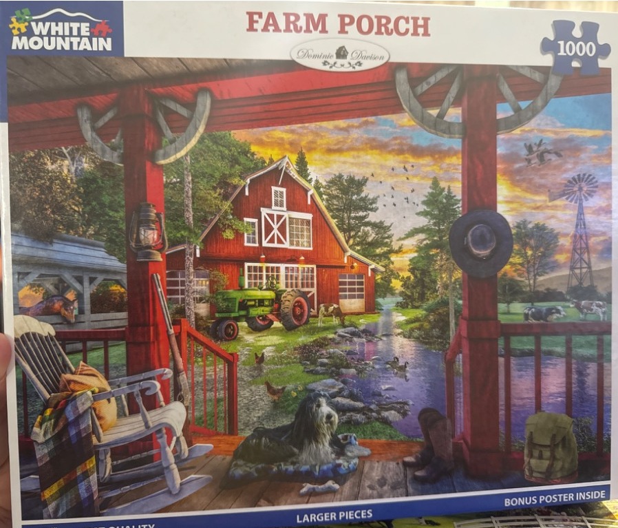 An idyllic farm scene viewed from a red porch featuring a barn, a green tractor, a dog, and a sunset over a creek.