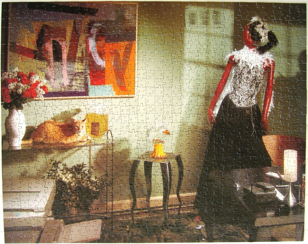 Mannequin in elaborate dress and orange cat on shelf.