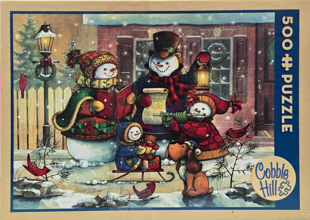 A family of snowmen carolers and a dog standing in the snow in front of a brick house.