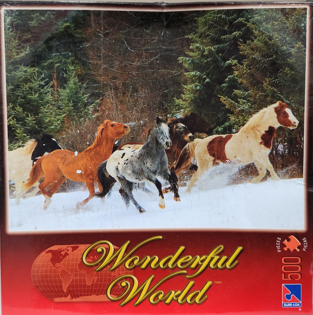 A herd of horses galloping through deep snow in front of a dense pine forest.
