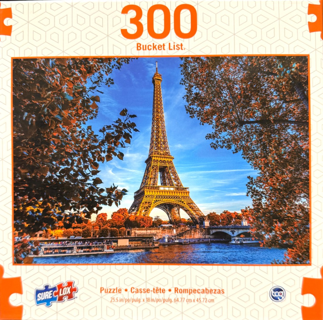 The Eiffel Tower in Paris captured in the golden light of autumn, framed by orange-leafed trees along a riverbank.