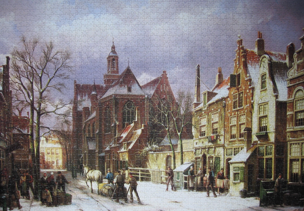A wintry 17th-century Dutch village scene with a large church and stone houses dusted in snow.