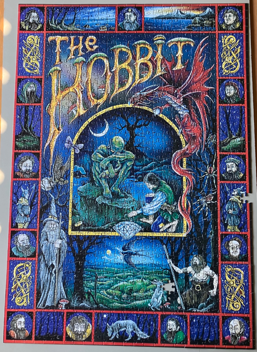 The Hobbit fantasy art illustration featuring a dragon, Gollum, Bilbo, and portraits of dwarves.