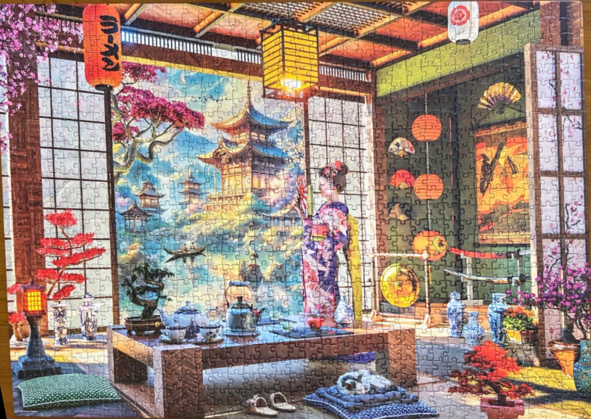 A Japanese-themed room with a view of a pagoda, a woman in a kimono, lanterns, and bonsai trees.