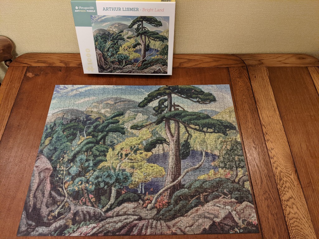 A painting of a rocky Canadian landscape featuring a tall, windswept pine tree overlooking a dark blue mountain lake.