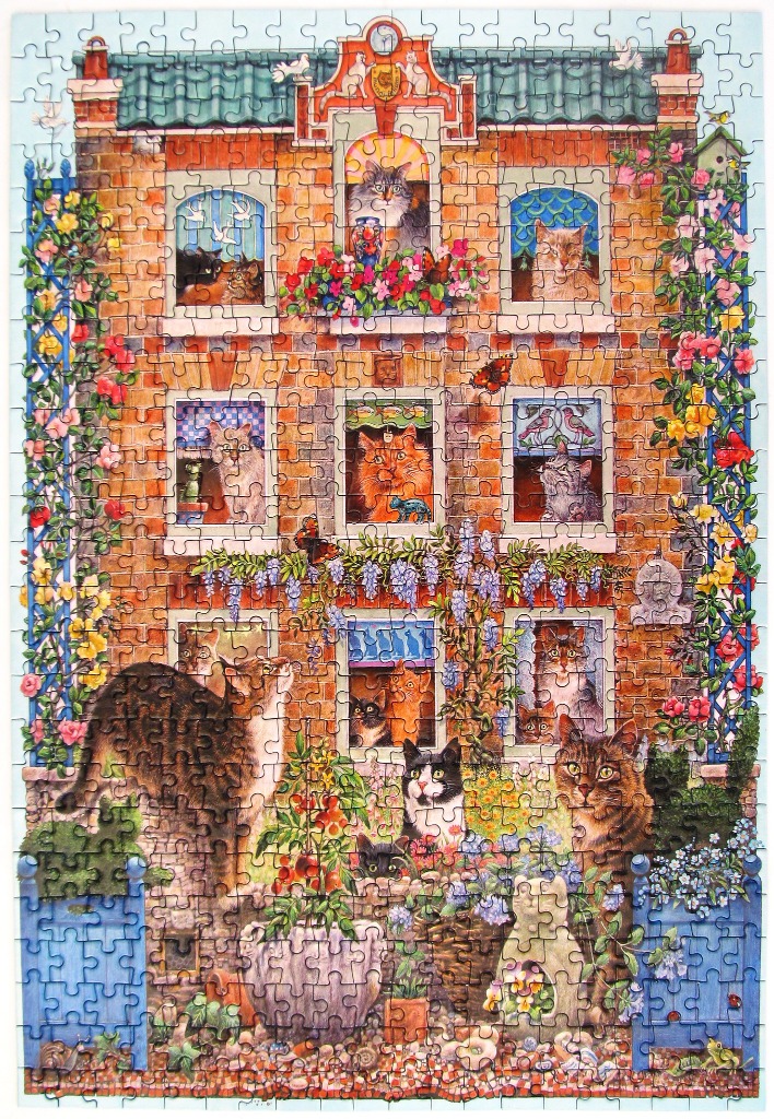 A whimsical illustration of a brick townhome filled with various cats in windows and a garden in front.