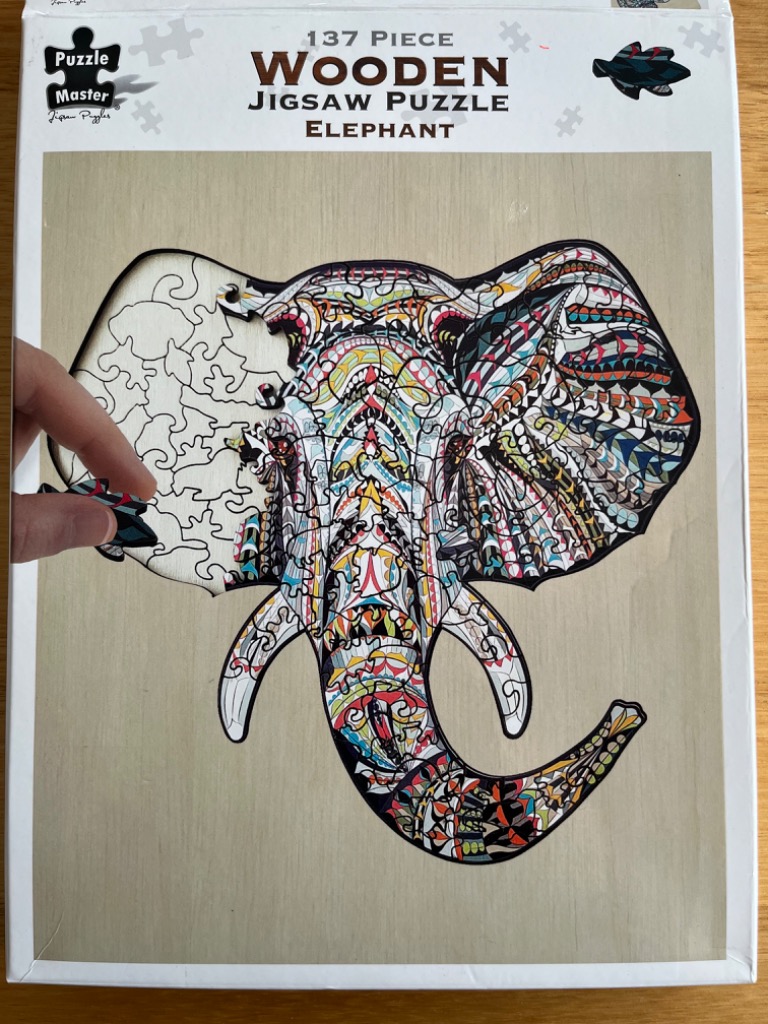 An elephant head illustration filled with intricate, colorful bohemian-style patterns.