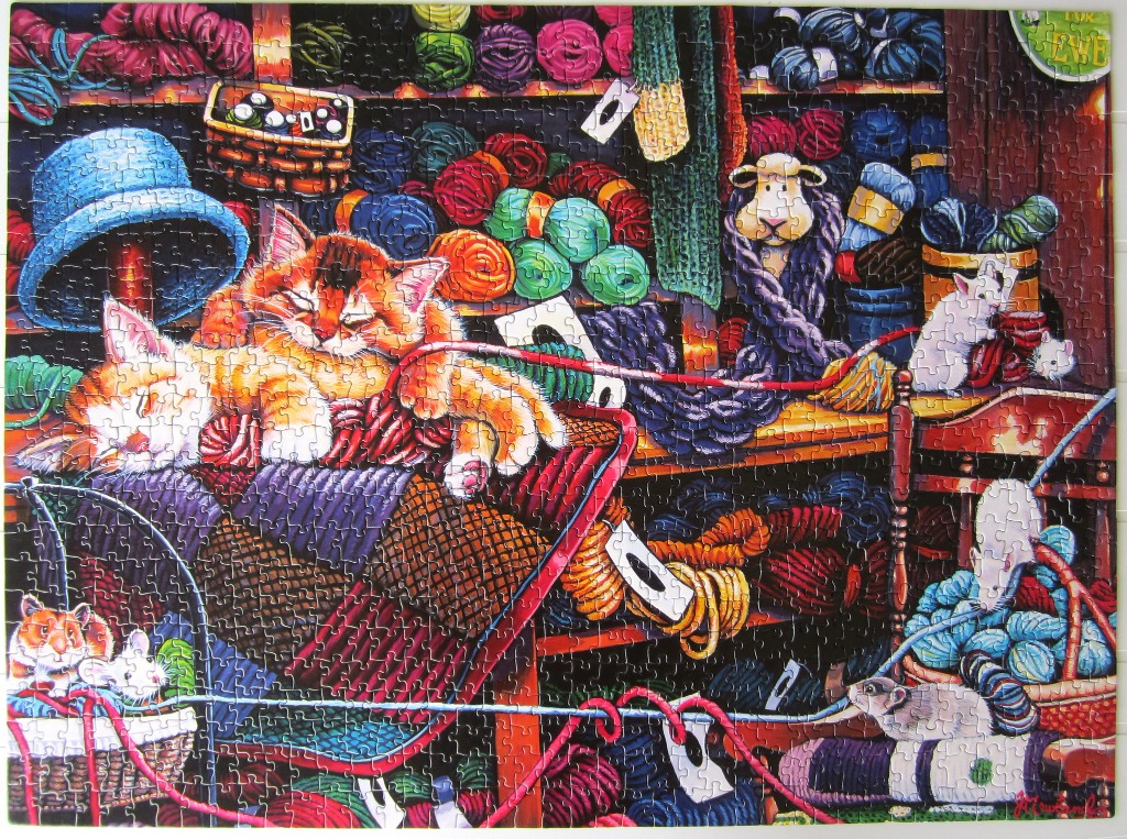 Two ginger kittens sleeping in a yarn shop with hamsters and mice.