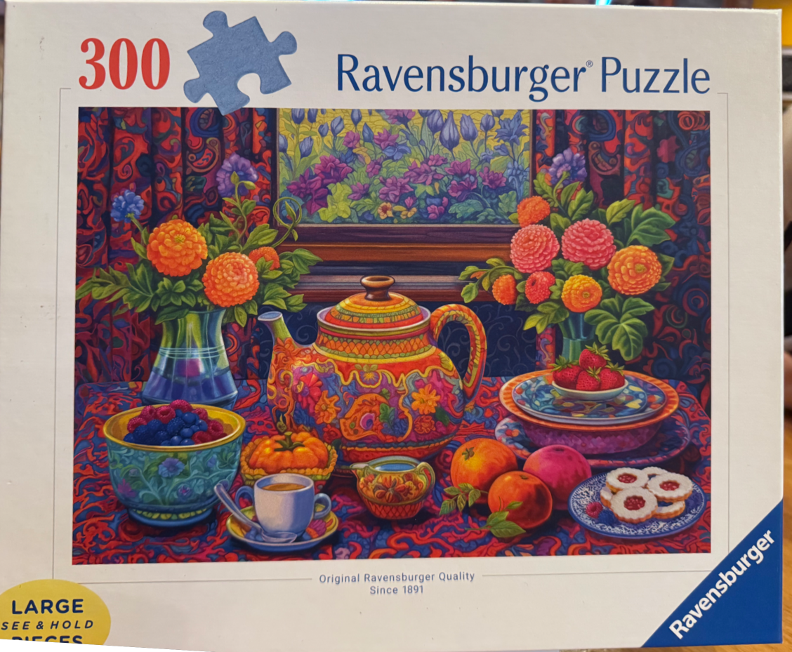 A vibrantly patterned illustration of a table set with an ornate teapot, fresh fruit, cookies, and floral arrangements.