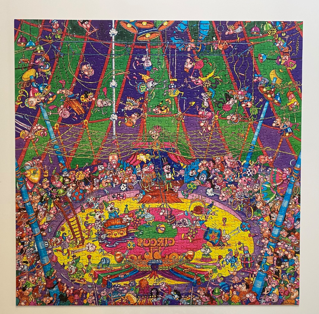 A chaotic, humorous cartoon illustration of a bustling circus performance featuring numerous performers and onlookers.