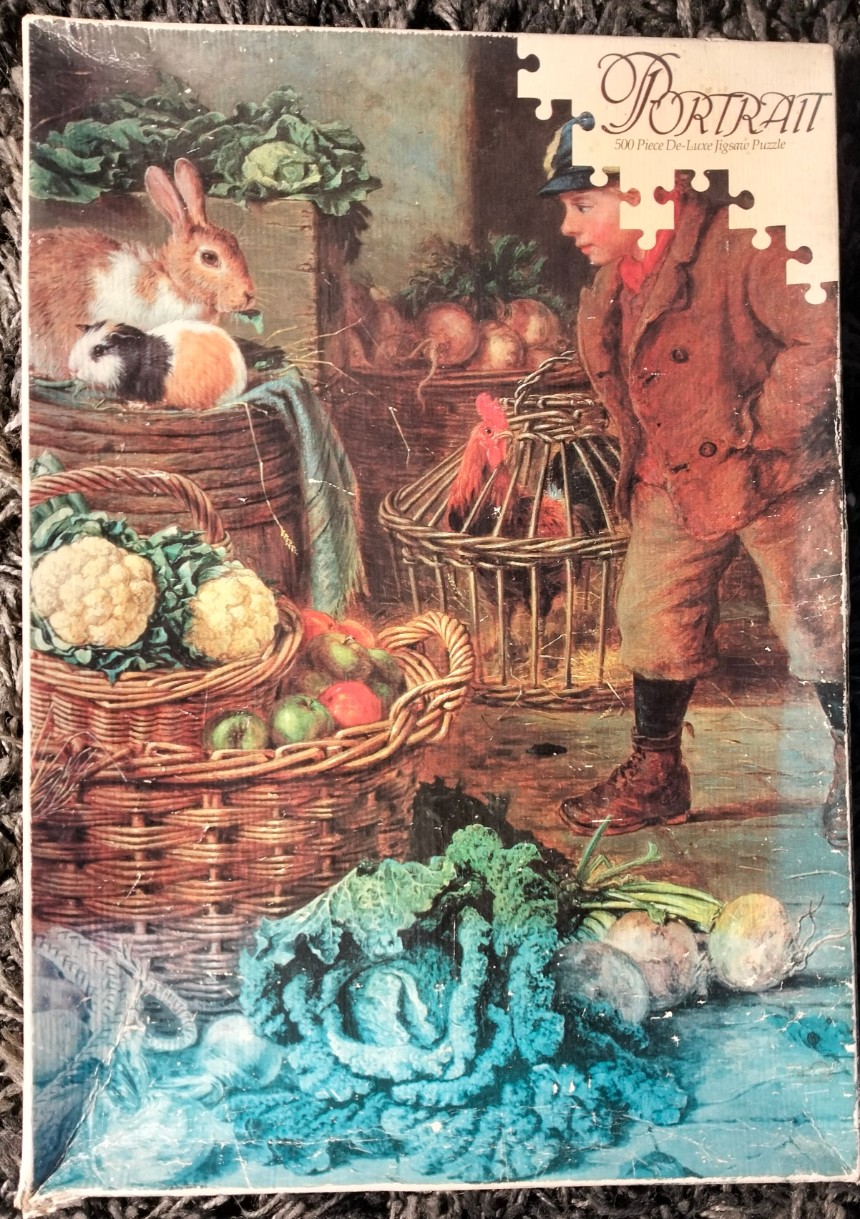 A young boy in a brown coat observes a rooster in a cage amidst a rustic collection of produce and small animals.