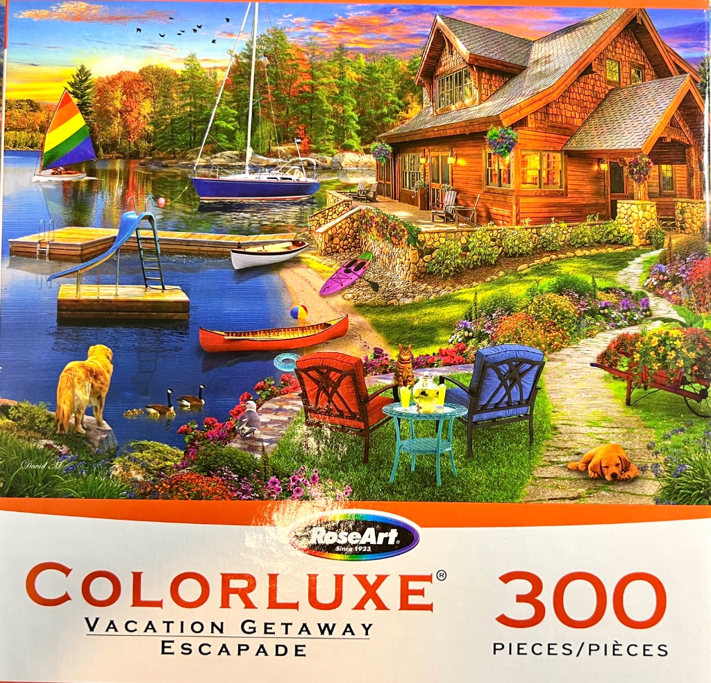 A peaceful lakeside cabin scene at sunset with a sailboat, a dog, and a beautiful garden.