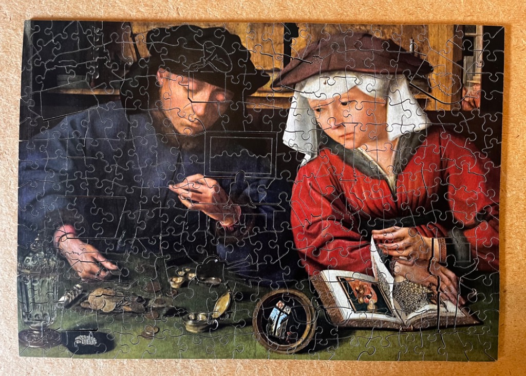 A Renaissance oil painting depicting a man and woman at a table with coins and a book.