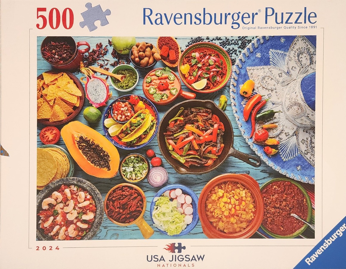 Overhead view of a vibrant Mexican feast featuring various bowls, ingredients, and a large blue sombrero.
