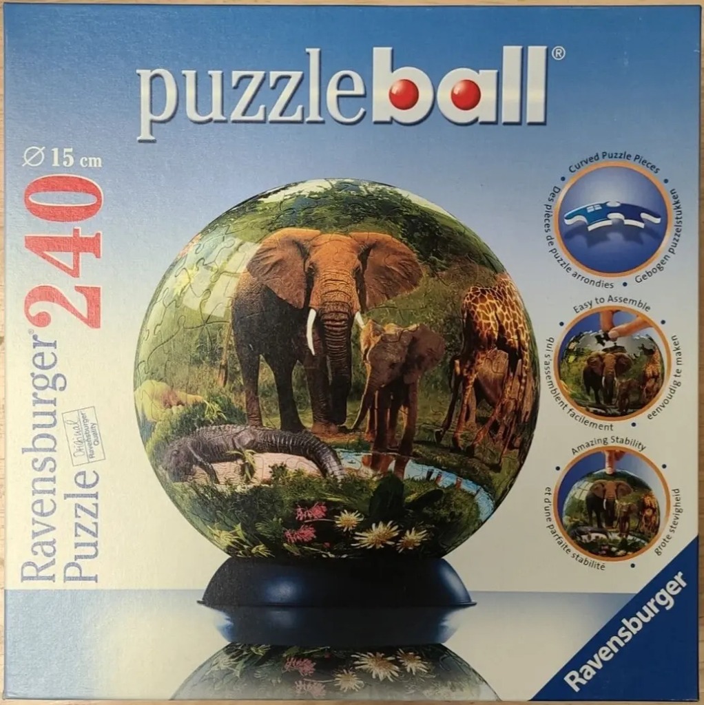 A spherical jigsaw puzzle featuring a vibrant African savanna scene with an elephant, baby elephant, and giraffe.