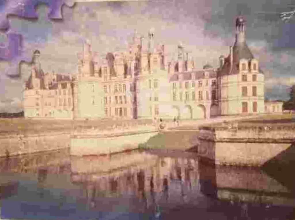 The Chateau de Chambord castle reflected in the waters of a moat under a soft, overcast sky.