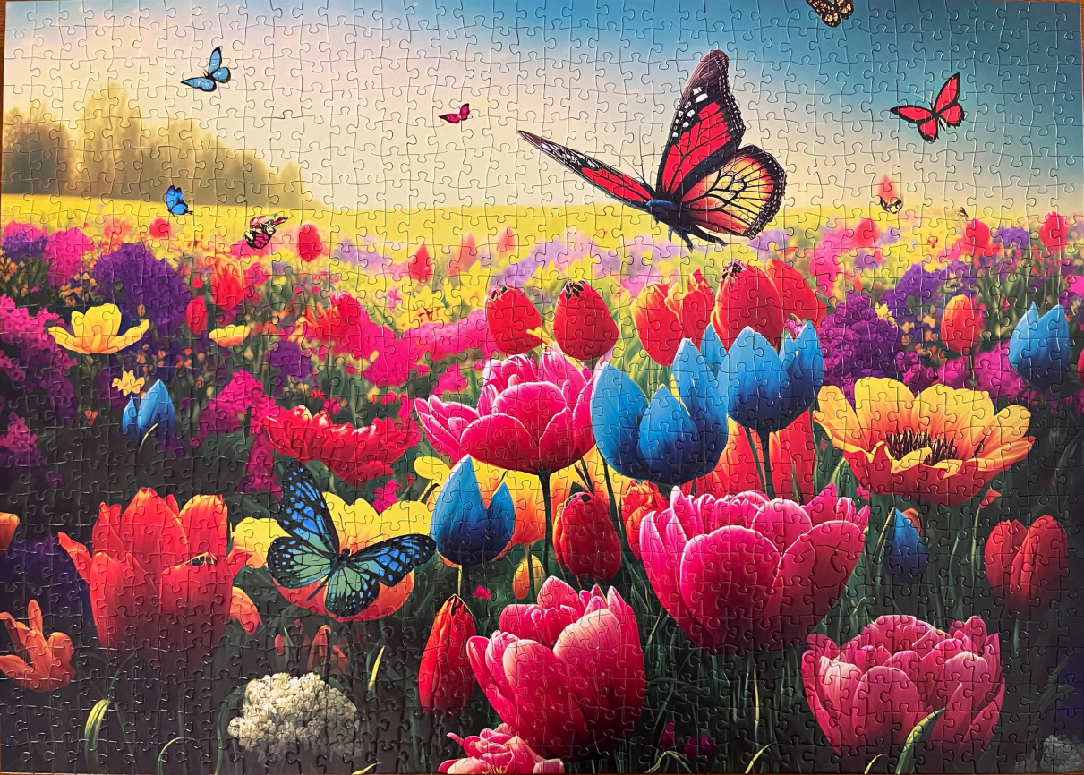 Vibrant flower garden filled with colorful tulips and butterflies under a soft sky.