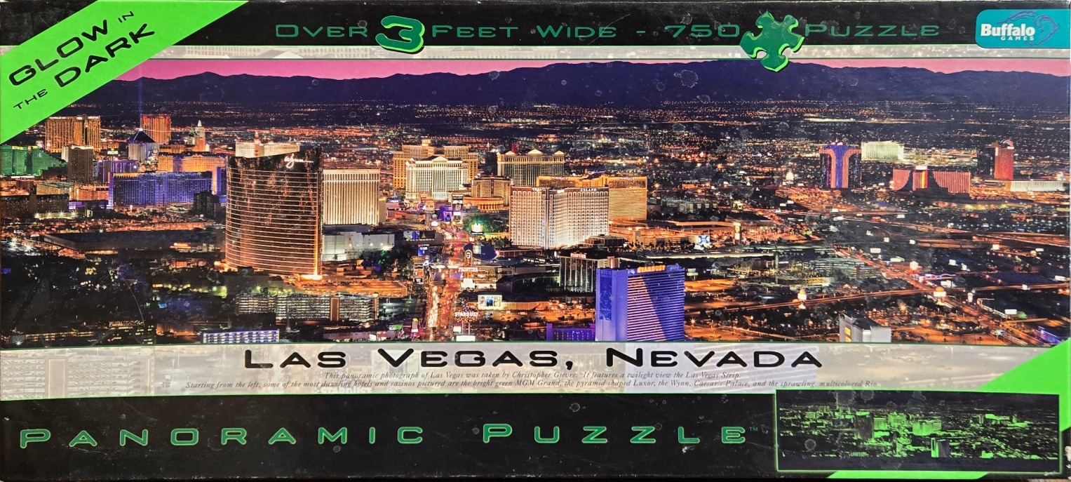 Aerial night view of the illuminated Las Vegas Strip with the desert mountains in the background