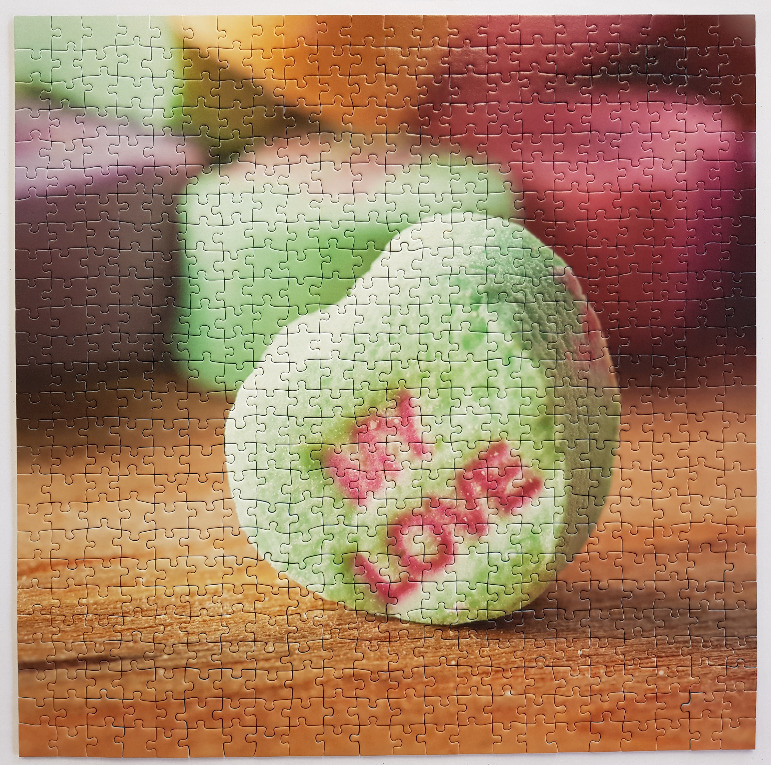 A heart-shaped candy with the word 