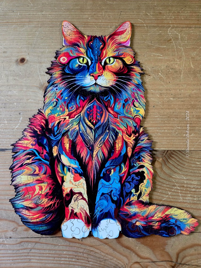 An intricately patterned, psychedelic illustration of a seated cat with vibrant, colorful fur.