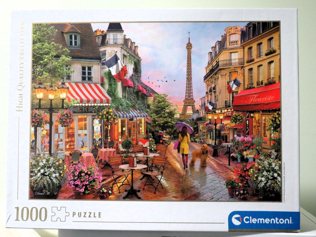 A romantic Parisian street scene featuring the Eiffel Tower, a woman with an umbrella, and a dog on a rainy day.