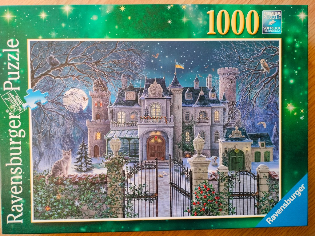 A moonlit winter scene of a stone castle with a cat on a wall and a garden gate.