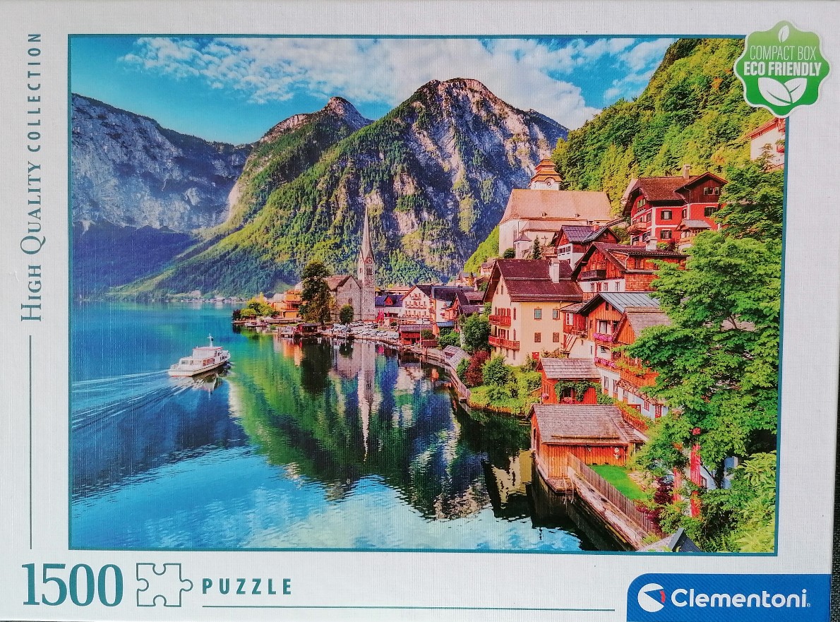 Scenic photograph of Hallstatt, Austria, featuring a lakeside village, church spire, and mountains.