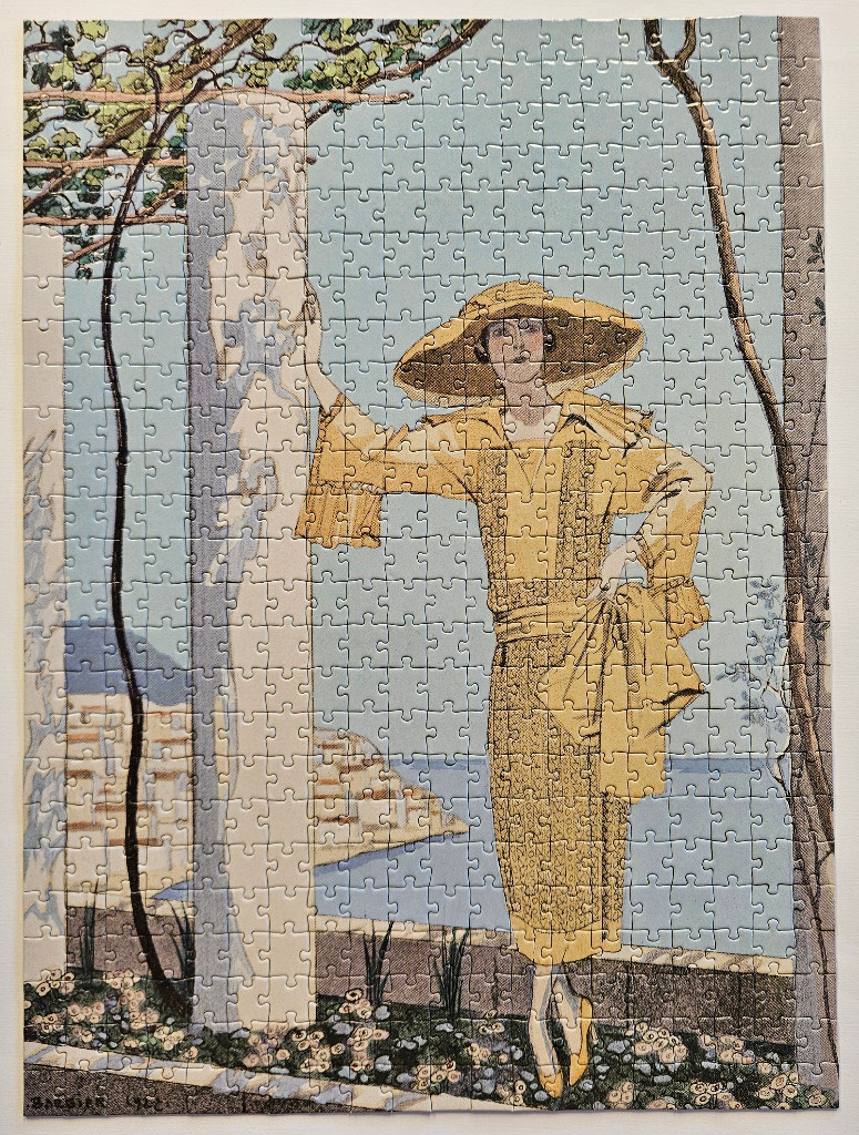 An Art Deco illustration of a woman in a yellow dress and hat standing on a balcony overlooking the sea.
