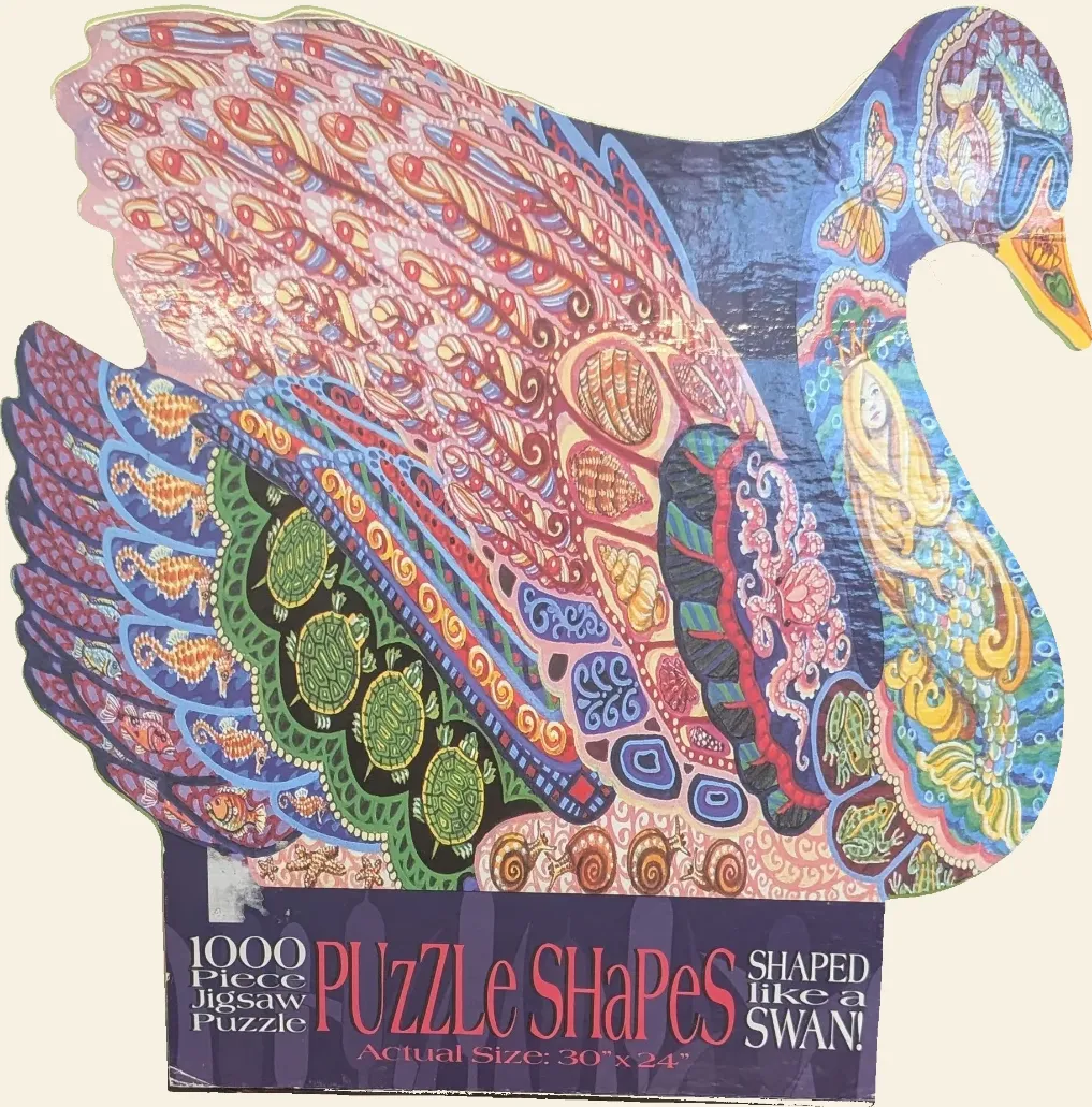 A die-cut illustration of a swan filled with intricate, colorful patterns of sea creatures and a mermaid.