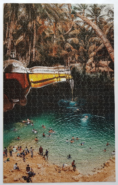 A surreal image of a large bottle pouring into a tropical lagoon filled with swimmers.