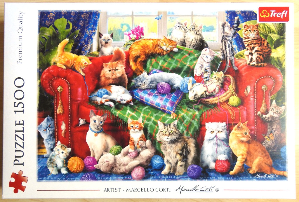 A vibrant illustration of many different kittens and cats playing on and around a plush red velvet sofa.