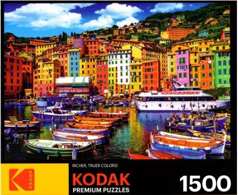 A sunny, colorful coastal village in Italy with boats in the harbor.