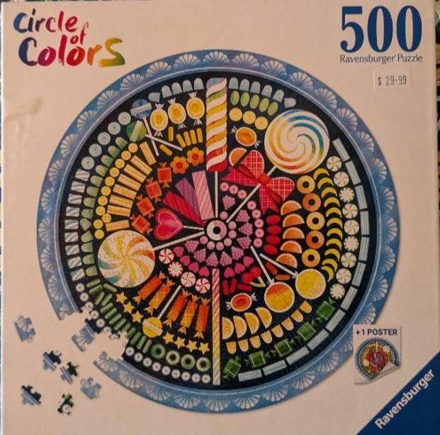 A circular arrangement of colorful candies and sweets displayed on a dark background.