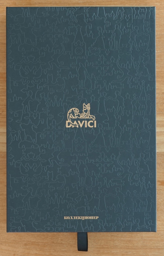 Dark green textured surface with a repeating embossed pattern of silhouettes and a central gold logo.