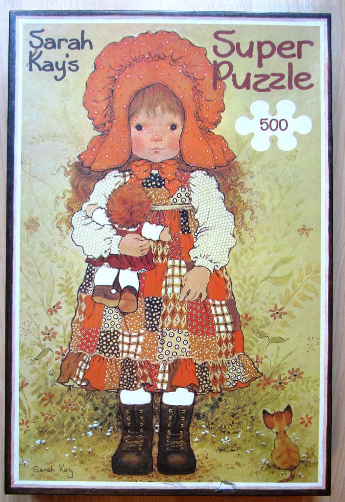 Illustration of a young girl wearing a bonnet and patchwork dress holding a doll in a field with a kitten.
