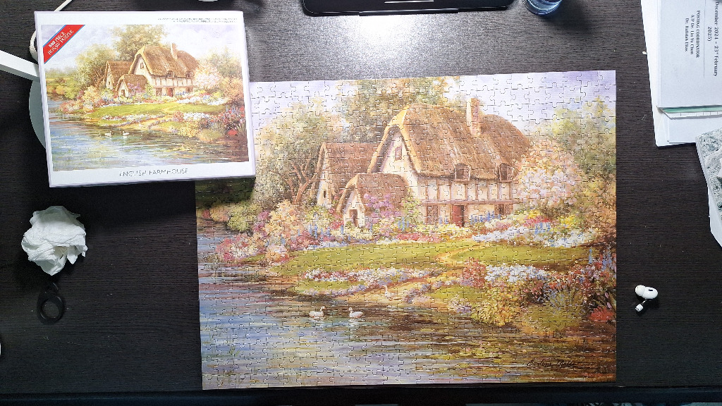 A peaceful English countryside scene featuring a thatched-roof farmhouse by a pond surrounded by colorful flowers.