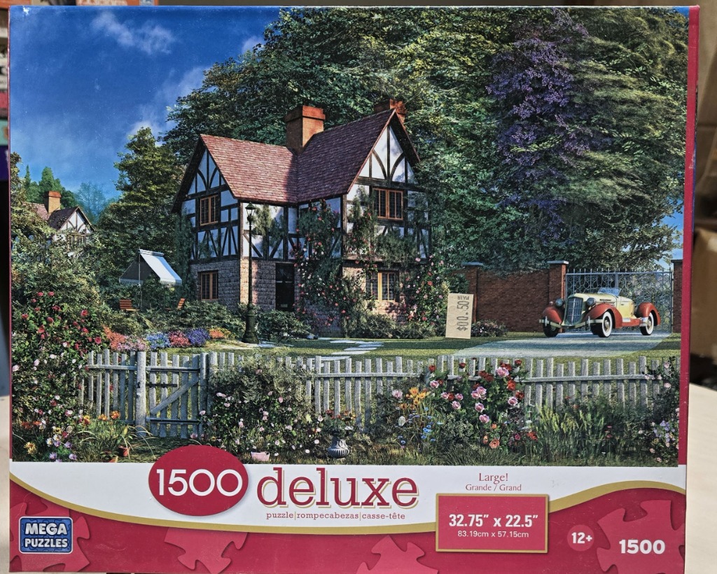 A charming English cottage with timber-framing, a picket fence, and a vintage yellow car in a lush garden setting.