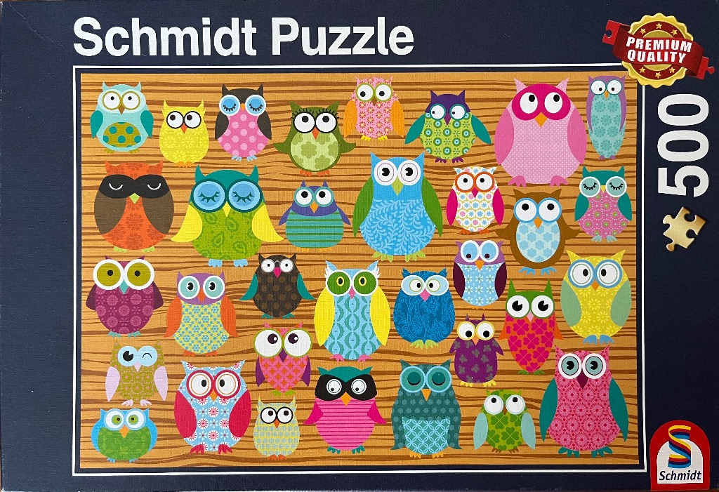 A whimsical illustration of many colorful, patterned cartoon owls arranged on a wood-grain background.