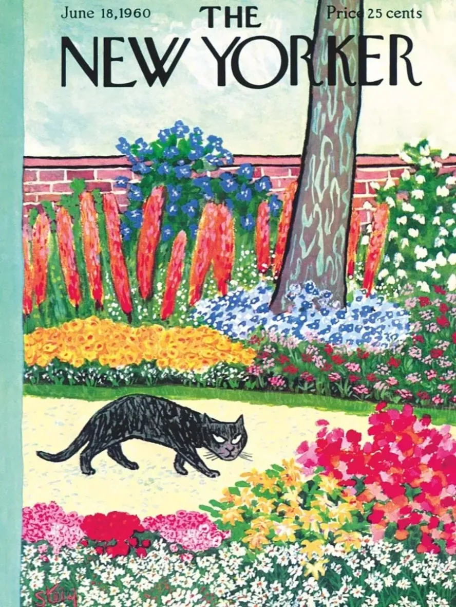 A black cat prowling through a lush, colorful garden filled with blooming flowers.