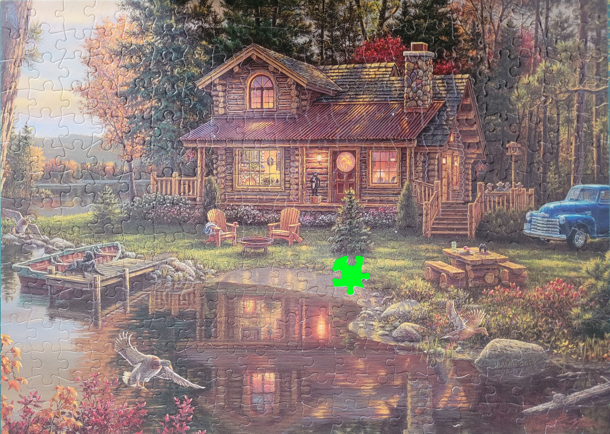 A cozy log cabin nestled by a reflective lake in a forest at sunset with a blue vintage truck parked nearby.