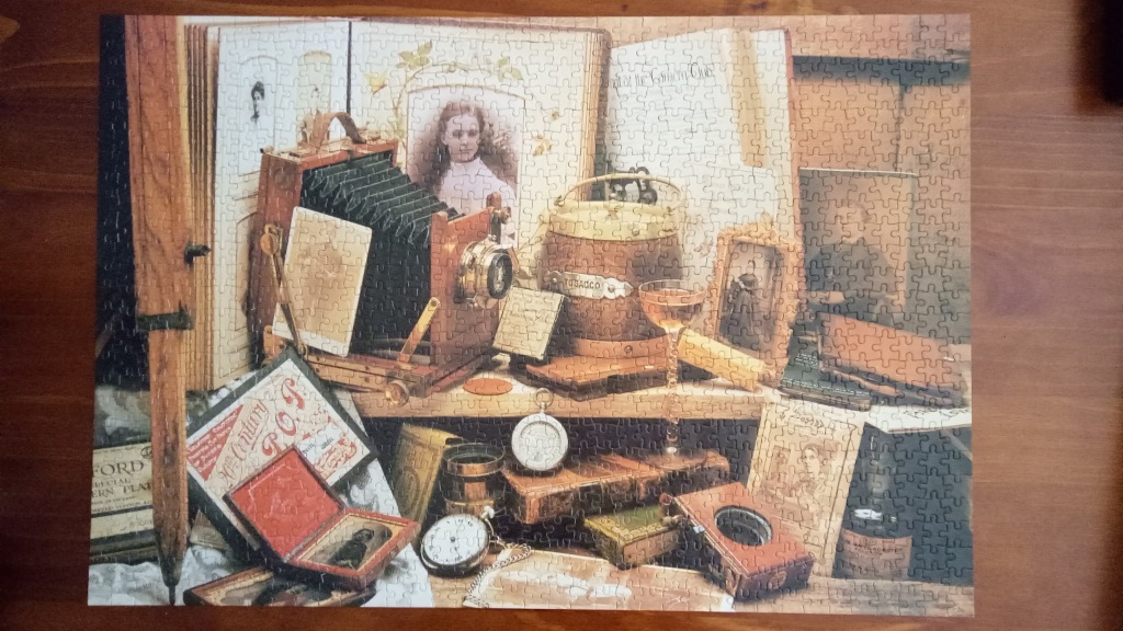 Vintage photography still life with an old bellows camera, antique books, and period memorabilia.