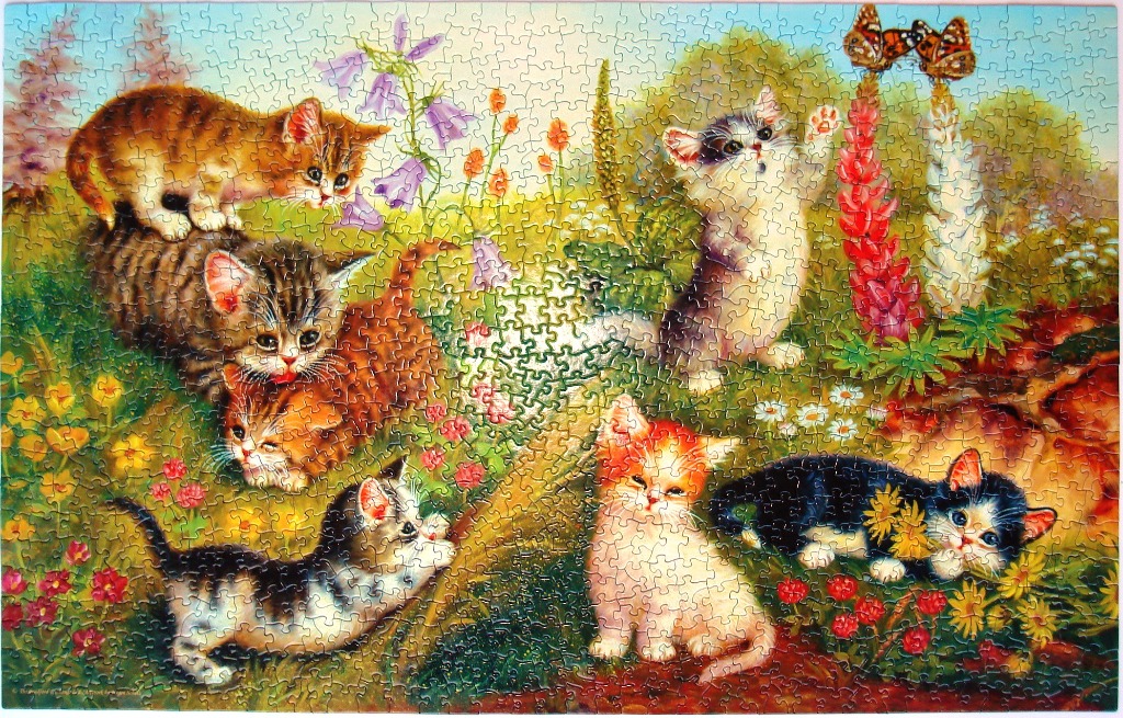 Six kittens playing in a colorful flower garden with butterflies